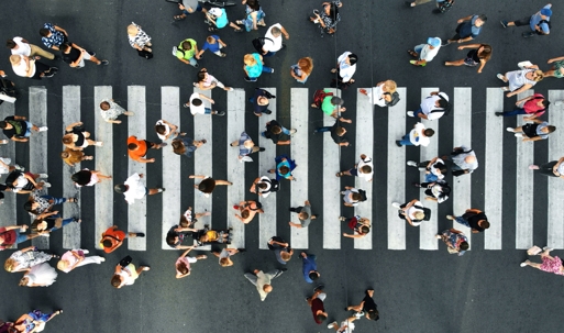 Aerial. Pedestrians on pedestrian crosswalk. Top view. stock photo