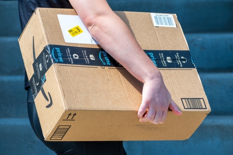 An Amazon Flex driver delivers a large package