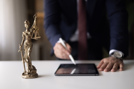 Digital tablet Judge or Legal advisor lawyer examining and signing legal documents stock photo