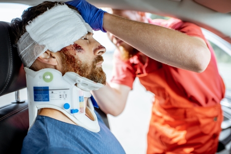Medic providing emergency medical assistance after the road accident stock photo