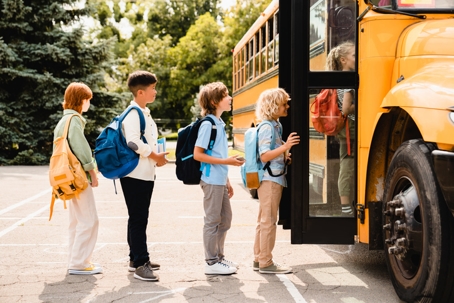 Children getting on school bus photo