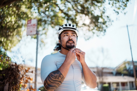 Man putting on bike helmet before heading out for a ride stock photo
