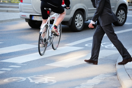 Business man crossing street in traffic stock photo
