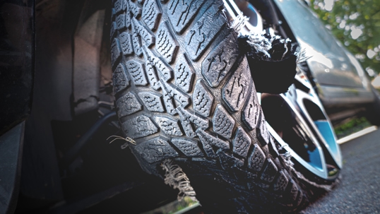 Damaged tire after tire explosion at high speed on the highway stock photo
