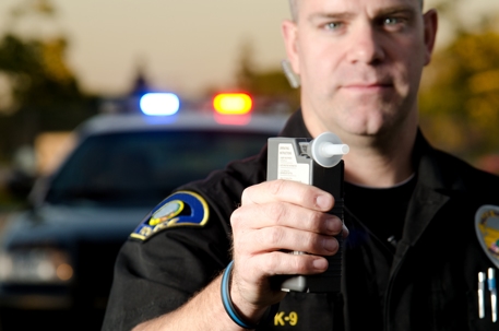 Police officer with a breathalyzer