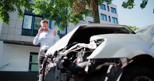 Worried Mechanic Fixes Broken Engine After Car Crash stock photo