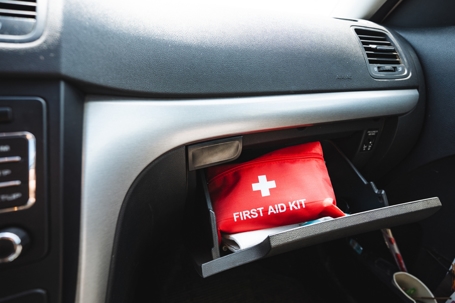 A first aid kit is put in the glove compartment of the car, a compact bag for medicines, a red box with pills