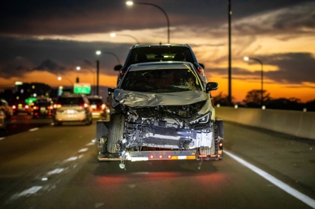wrecked car being towed