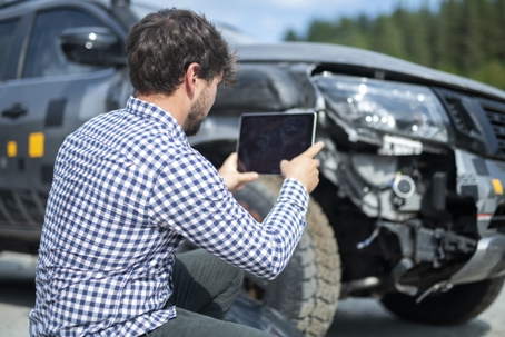 Insurance adjuster inspecting car. stock photo