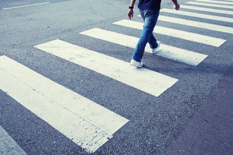 person walking across a crosswalk