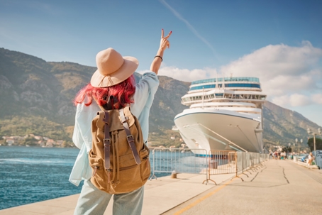 Tourist gesturing near cruise ship at Kotor bay, Montenegro stock photo