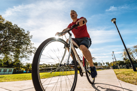 Mature caucasian man riding bicycle in Miami, USA stock photo