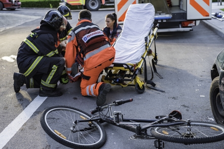 Rescue team helping cyclist stock photo