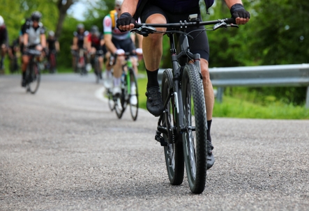 Gravel bike racing on mixed terrain with other cyclists stock photo