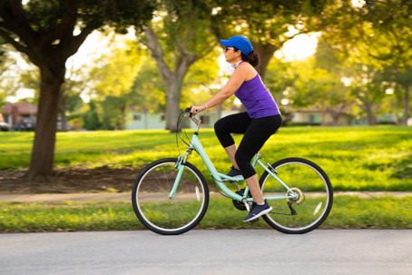 Woman cycling around the neighborhood stock photo