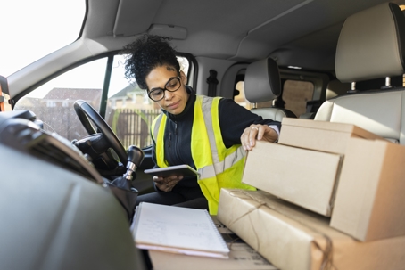 Organizing Her Parcels In The Delivery Van stock photo