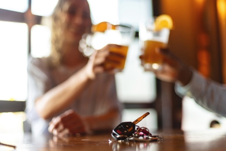couple drinking at a bar with car keys on the table