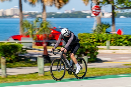 Long exposure stock photo man riding a road bike in Miami Key Biscayne stock photo