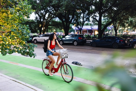 girl riding a beach cruiser bike