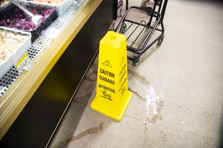 A customer about to step into a puddle of water in a store or supermarket