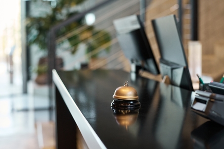 Hotel Reception Desk with Gold Bell on Counter stock photo