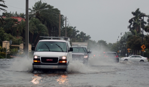 hydroplaning cars on a flooded road
