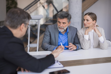 Lawyer consulting couple about personal injury claim stock photo