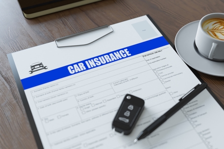 Car Insurance Form with Car Key Pen and Coffee stock photo