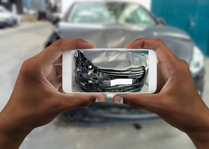 Man taking photo of his car with damages stock photo