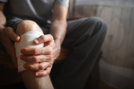 Man with knee pain at home stock photo