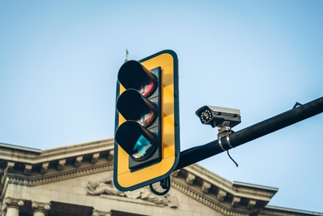 Traffic light and a camera on blue sky background. Traffic control concept. stock photo