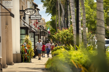 People walk on the sidewalk of Main Street downtown Naples Florida stock photo
