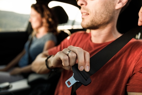 Close up of fastening seatbelt in a car. stock photo