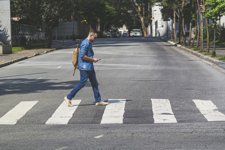 Young man walking at crosswalk on a Sao Paulo's street stock photo