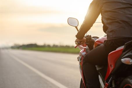 Rear View Of Man Riding Motorcycle On Road stock photo