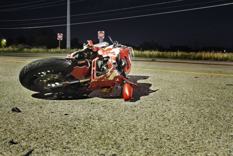 crashed motorbike on a dark road