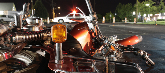 Close up photograph of a crashed motorcycle and police car stock photo