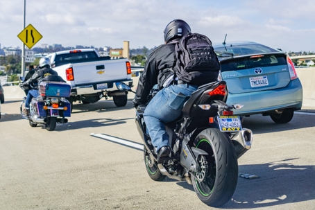 Motorcyclists riding through heavy traffic