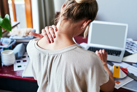 Woman holding her neck in pain