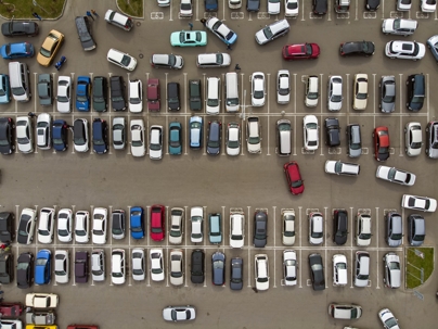 A view from above to the lines of parked cars. Heavy traffic in the parking lot. Searching for spaces in the busy car park. Cruising for parking in dormitory area. Difficulties of parking in the city stock photo