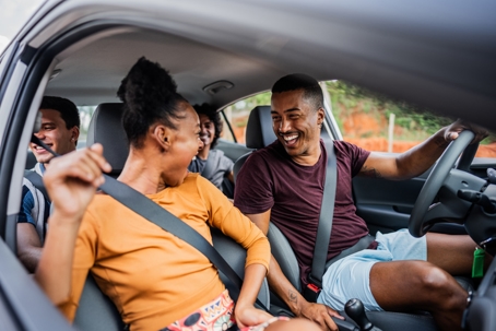 Friends talking on a car during a trip stock photo