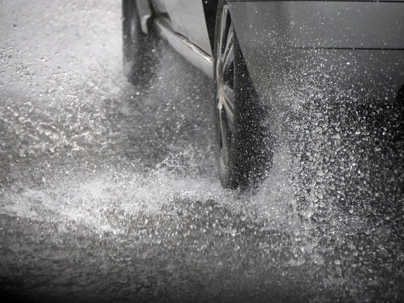 Car tire aquaplaning under heavy rain detail stock photo