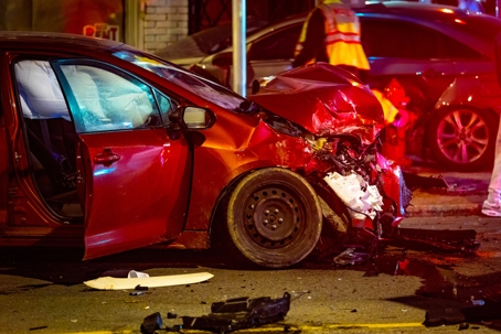 Severe Two-Car Crash on Street at Night stock photo