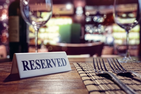 Reserved sign on restaurant table with bar background stock photo