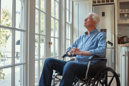 Cropped shot of a senior man sitting in his wheelchair at home