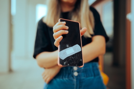 Hand Holding a Smashed Digital Display Temporary Fixed stock photo