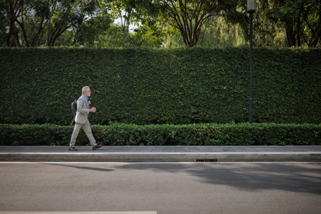 businessman walking with a backpack