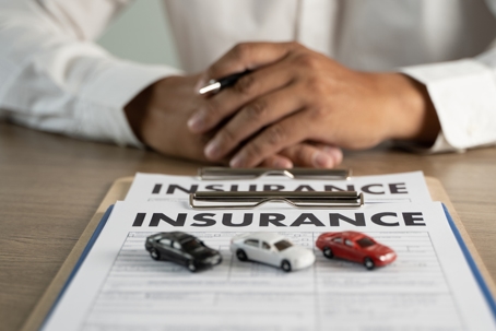 Concept of insurance man protective and car family health insurance policy examining stock photo