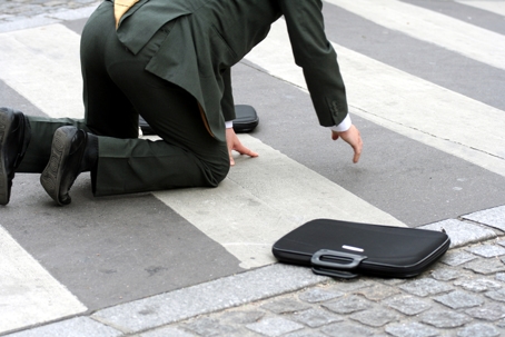 Businessman falling in the street
