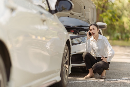 Asian woman calling insurance agent for help, fix car problem, help, emergency car repair stock photo
